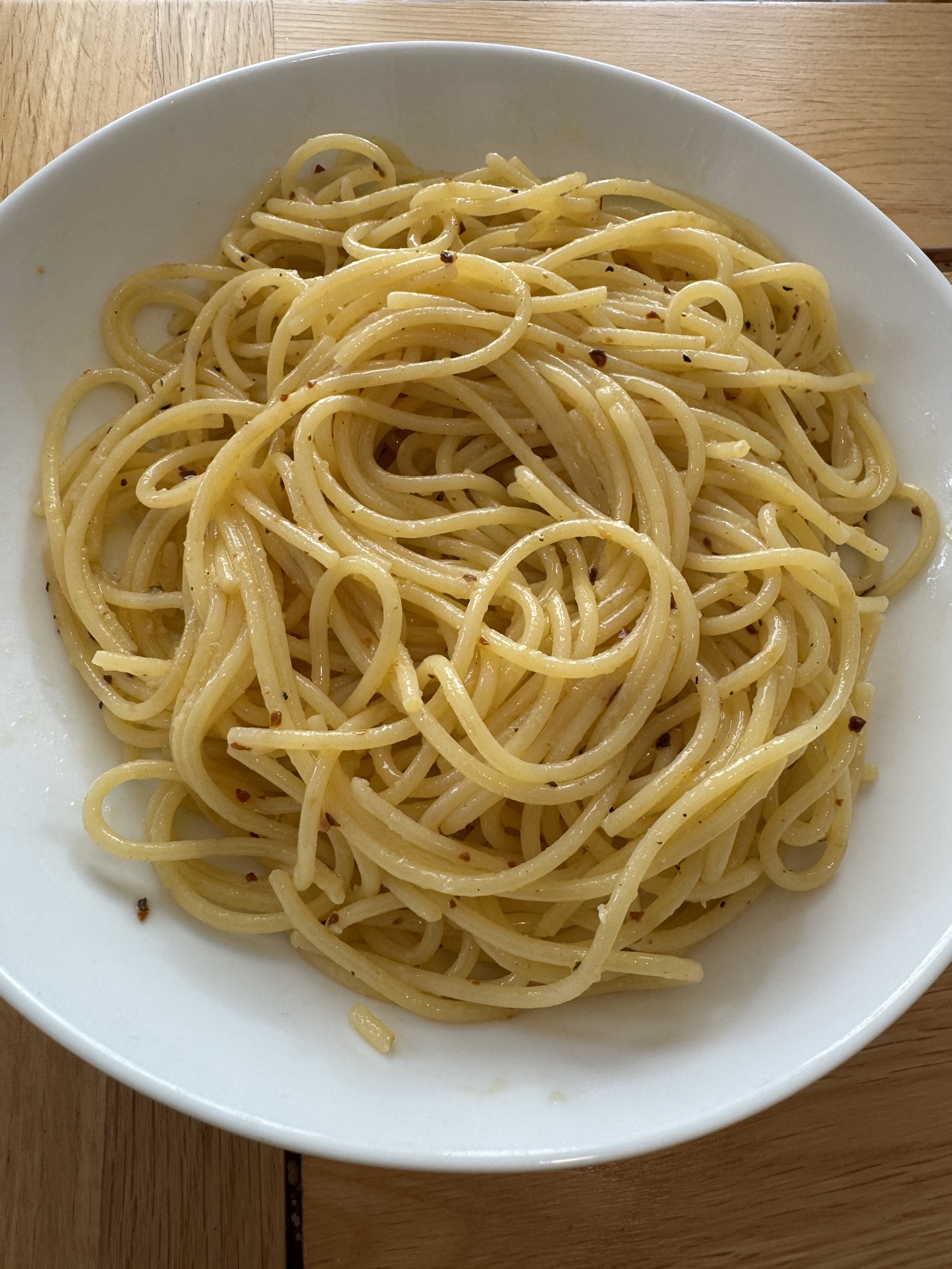 A plate of Spaghetti Aglio e Olio, featuring spaghetti tossed in olive oil, garlic, and red pepper flakes—a simple and classic Italian dish.
