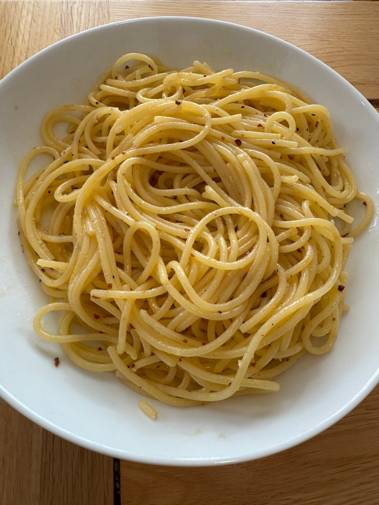 A plate of Spaghetti Aglio e Olio, featuring spaghetti tossed in olive oil, garlic, and red pepper flakes—a simple and classic Italian dish.