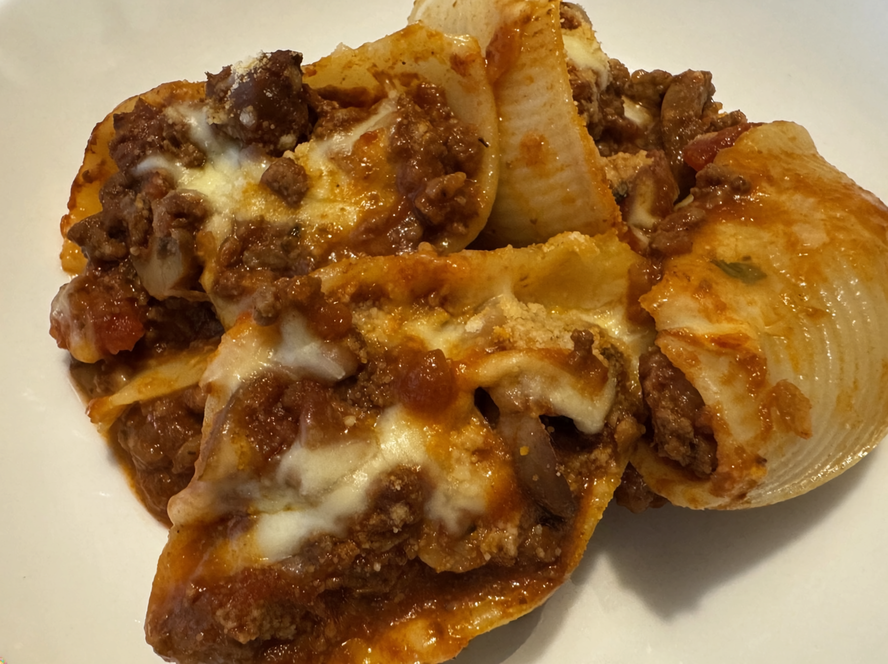 Close up of Gluten Free Bolognese Stuffed Conchiglioni with large Gluten Free Conchiglioni (shells) filled with bolognese sauce and baked with melted cheese
